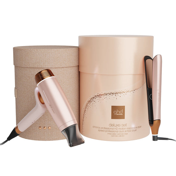 A ghd Delicate Set hair styling kit featuring a rose gold hair dryer, a flat iron, and a cylindrical presentation box on a white background.