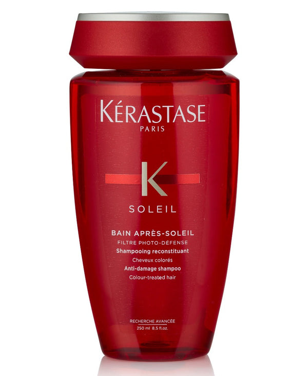 A red bottle of Kérastase Bain Après Soleil shampoo with UV filters for colour-treated hair.