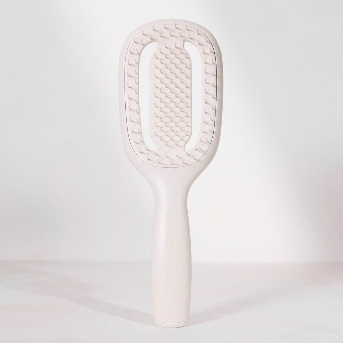 White paddle brush on a light gray background