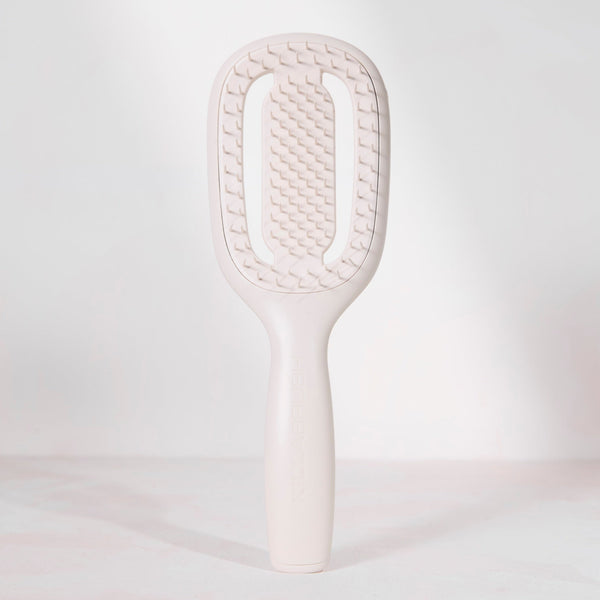 White paddle brush on a light gray background