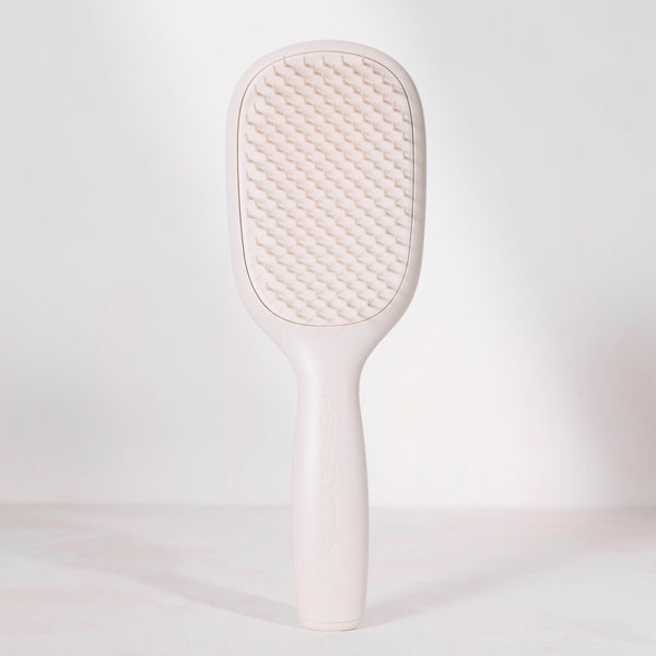 White paddle brush on a light gray background