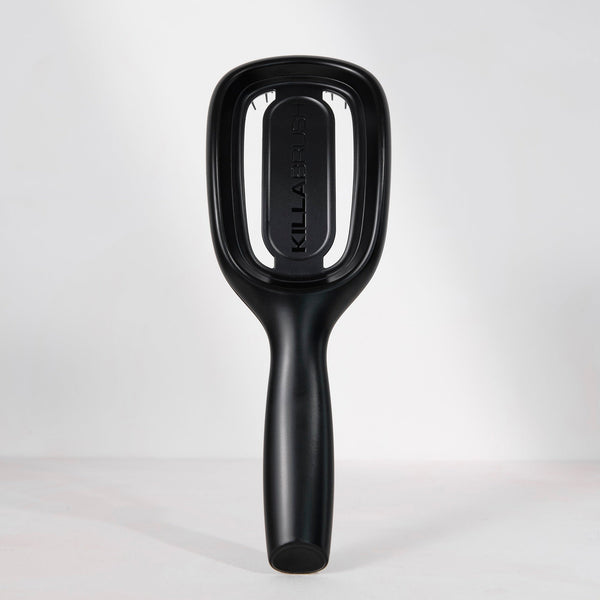 Black hairbrush with 'Killa' branding on a light gray background