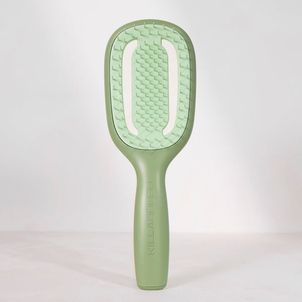 Green paddle brush on a white background