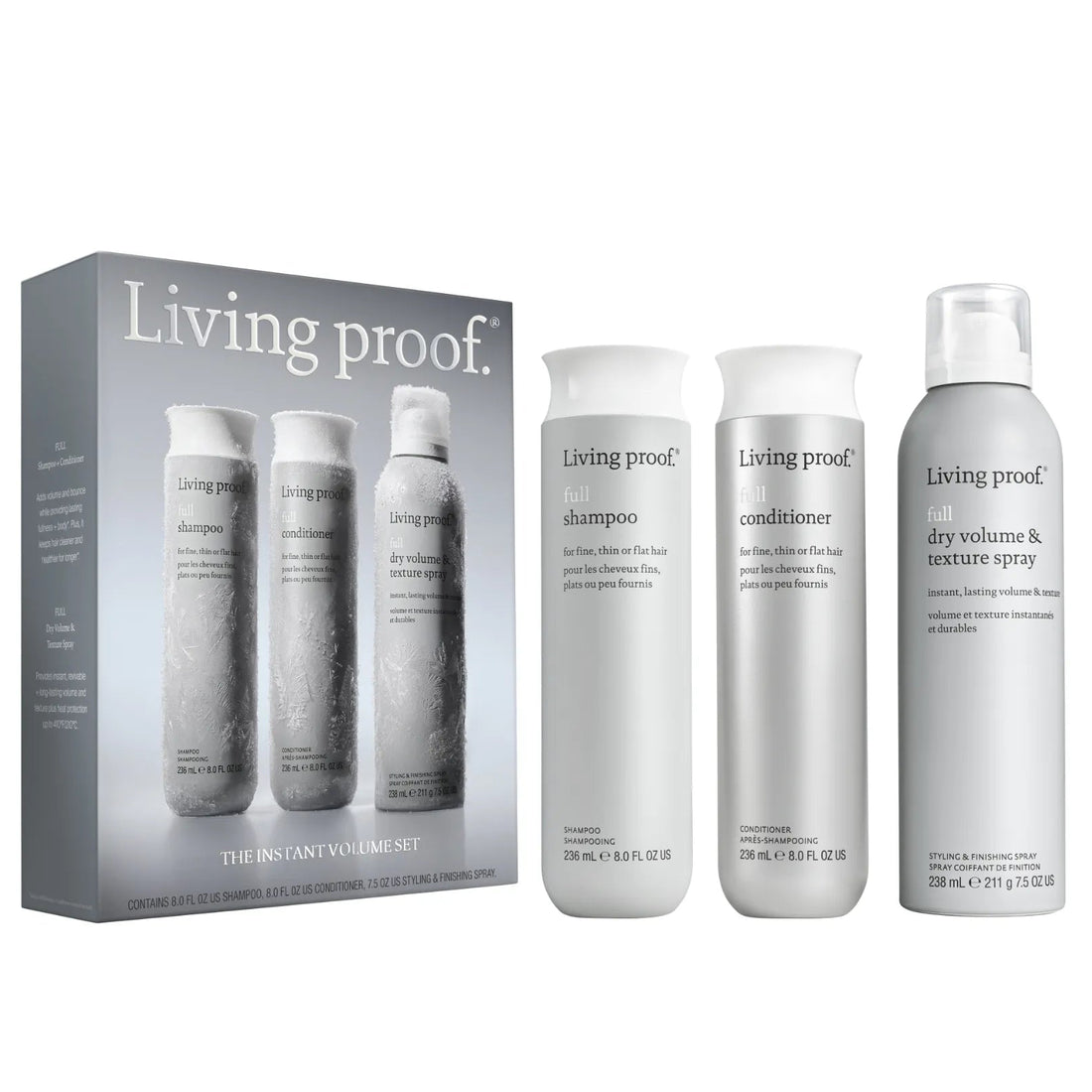 Living proof. Instant Volume Set hair care kit including a gray box with three smaller bottles and three white bottles (shampoo, conditioner, and dry volume & texture spray) on a white background.