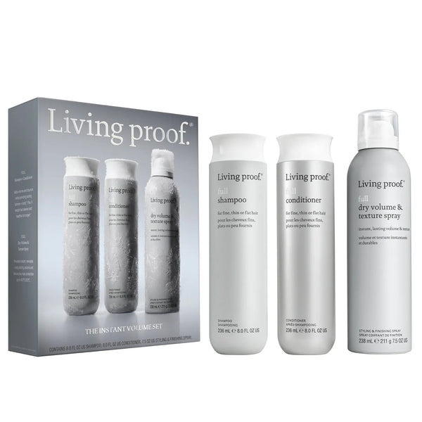 Living proof. Instant Volume Set hair care kit including a gray box with three smaller bottles and three white bottles (shampoo, conditioner, and dry volume & texture spray) on a white background.