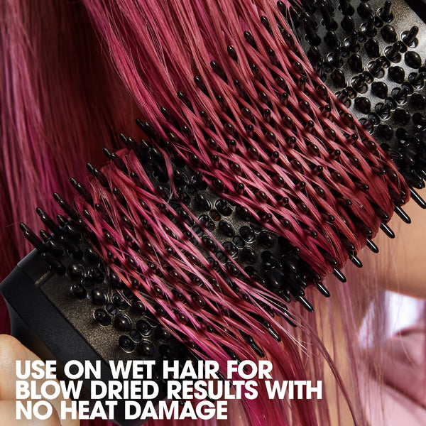 Hairbrush with pink hair being styled, text indicating use on wet hair for no heat damage.