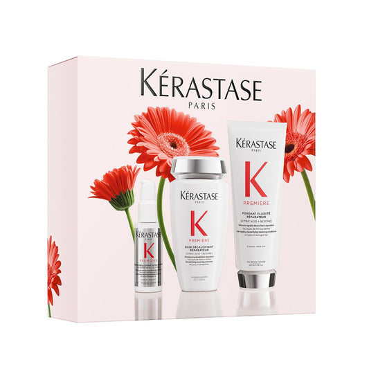 Kérastase hair care products with flowers on a white background