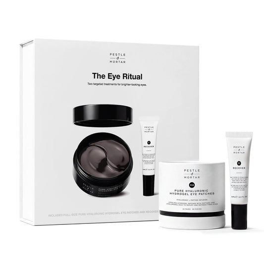 A skincare set from Purity of Paris called 'The Eye Ritual', featuring a white gift box, a white jar, and two white tubes with black caps, arranged on a clean white background.