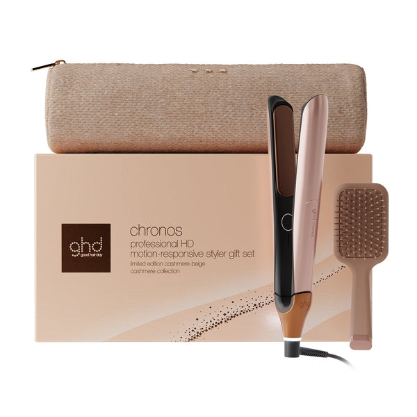 GHD Chronos professional H0 motion responsive styler gift set featuring a rose gold and black flat iron, a beige hairbrush, and a beige zippered pouch, arranged in front of the product box on a white background.