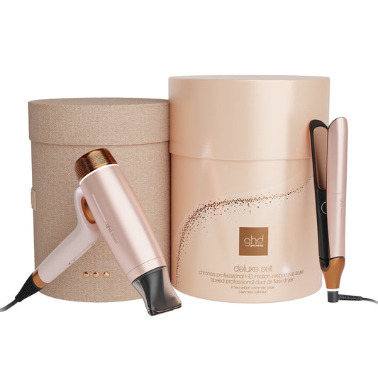 A ghd Delicate Set hair styling kit featuring a rose gold hair dryer, a flat iron, and a cylindrical presentation box on a white background.